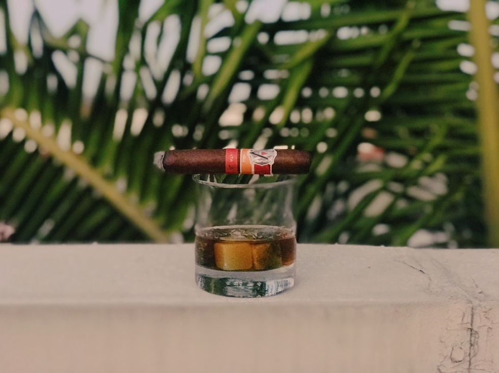 Cigar on a glass of whisky