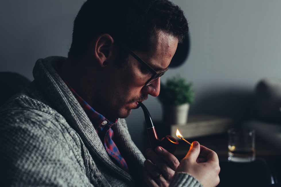 Man smoking pipe with tobacco