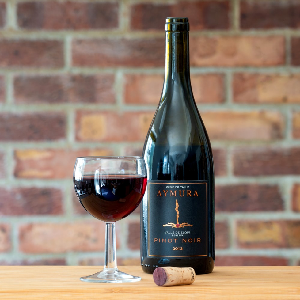 bottle of red wine with a glass of red wine