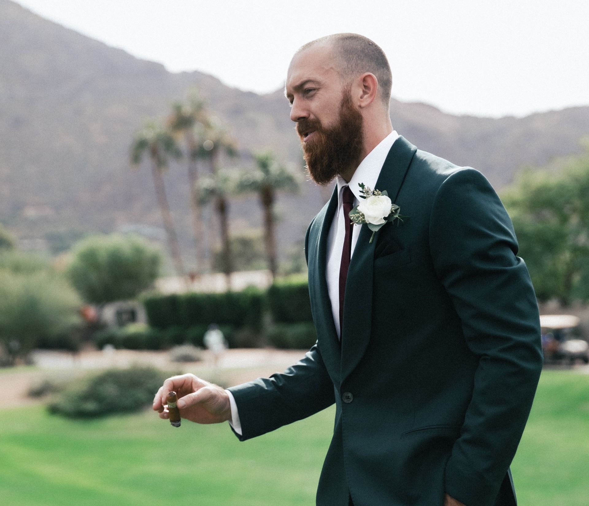 Man in a suit smoking a cigar at a wedding