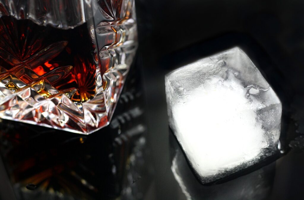 Whisky glass and ice cube