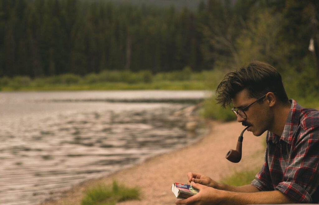 Man smoking pipe tobacco through a pipe