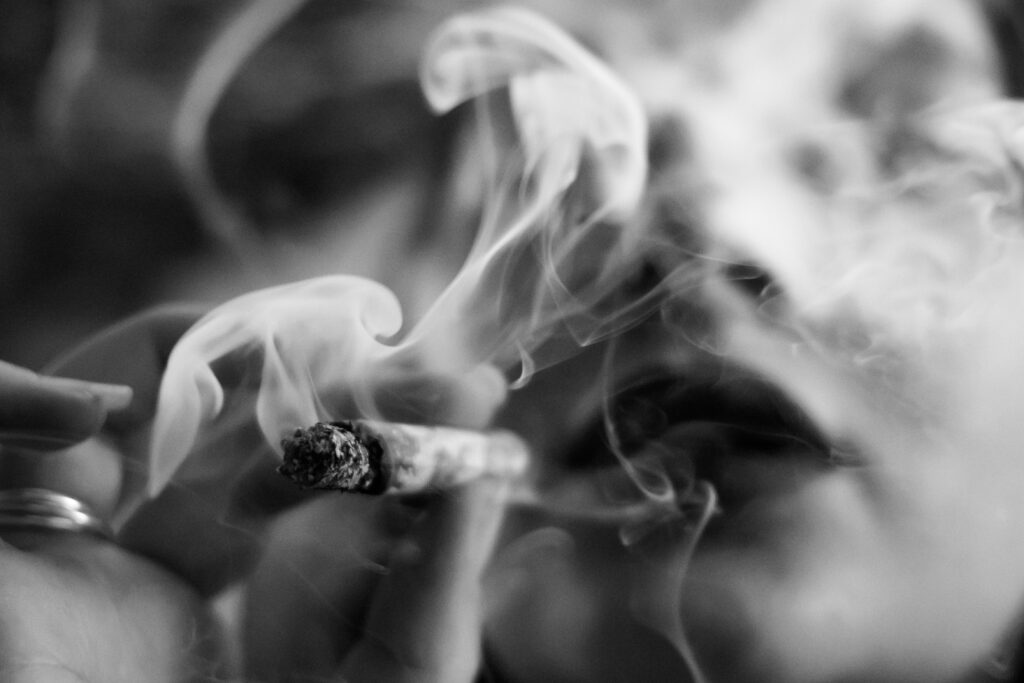 A close up of a woman smoking a cigarette
