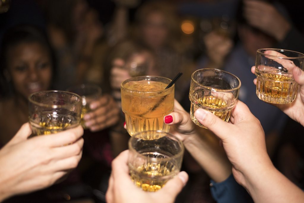 People cheersing glasses of whisky