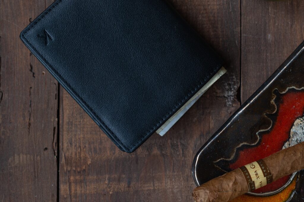 a wallet next to a cigar