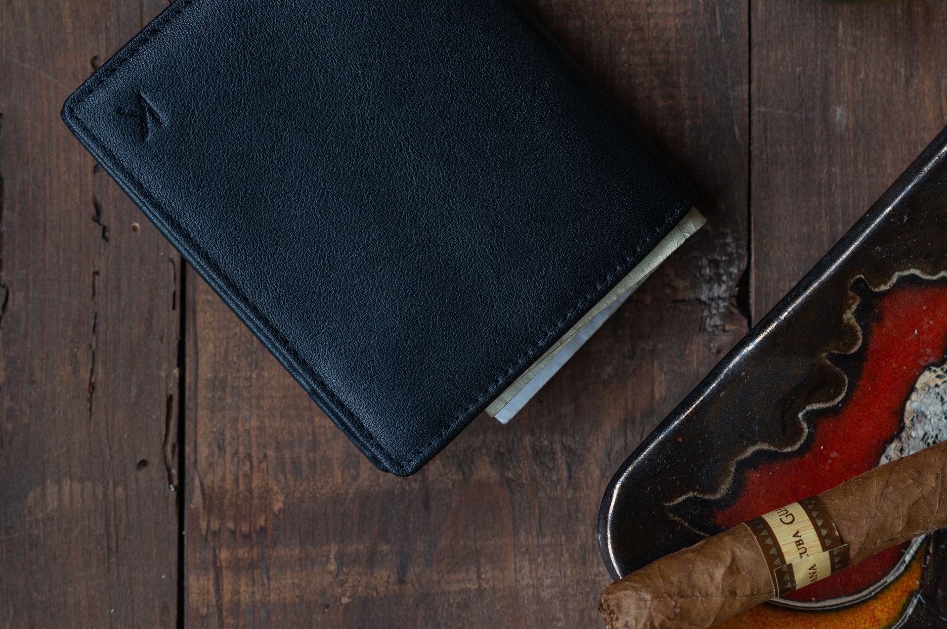 a wallet next to a cigar